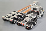 1/64 DCP / FIRST GEAR VINTAGE PETERBILT IN SILVER AND BLACK WITH TRI HEAVY HAULER TRAILER 60-1255
